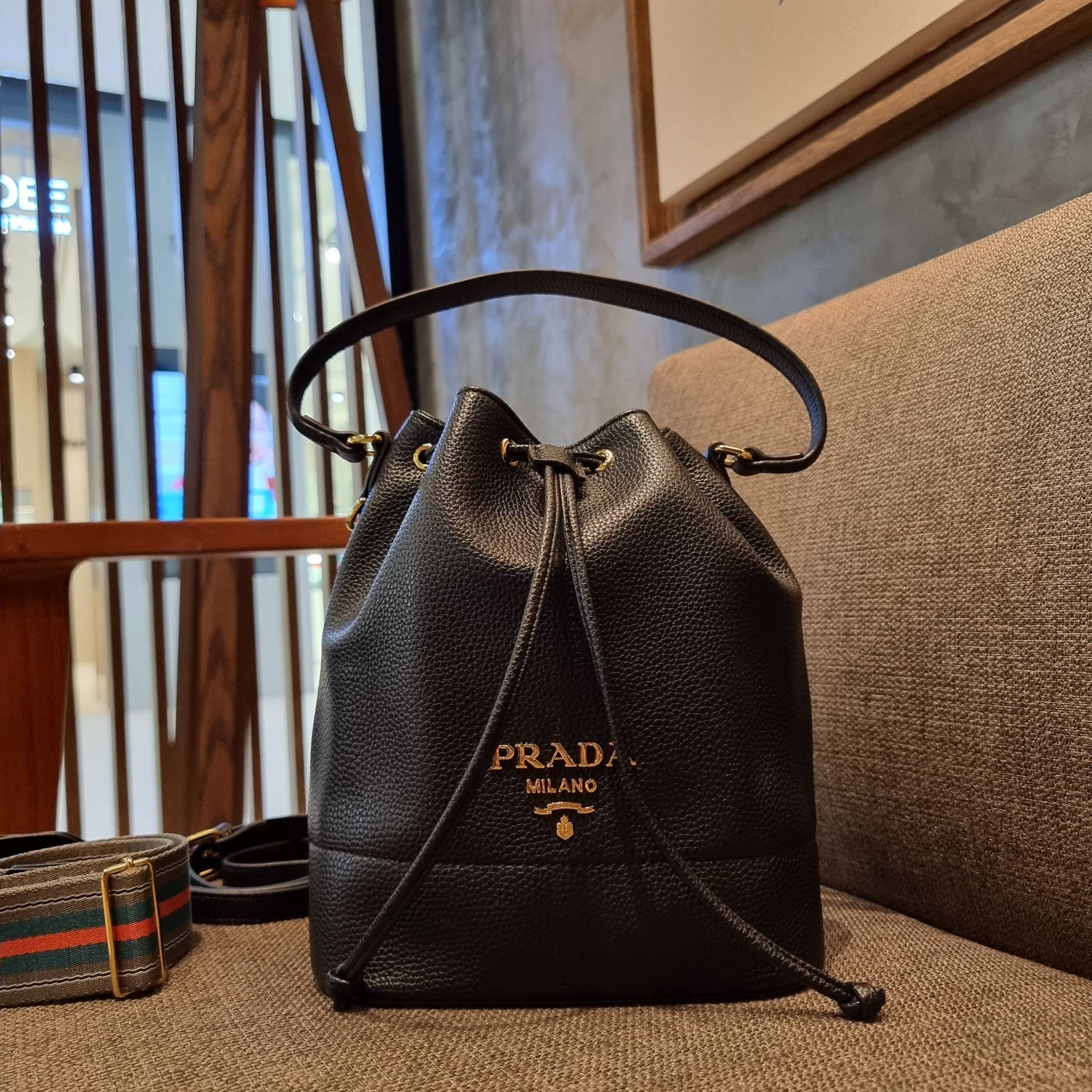 Prada leather bucket bag กระเป๋าสะพายทรงขนมจีบ ดีไซน์เรียบ แต่หรู น่าใช้มากๆ หนังสวยมาก วัสดุหนัง pepble สัมผัสนิ่มมือ ตกแต่งโลโก้สีทองตัดหนังดำ คือเลิศ!! ปากกระเป๋ารูดเปิดปิดได้ สะดวกใช้งาน ภายในโล่งกว้าง จุของได้เยอะ ไม่ธรรมดาเลย พิเศษ!! นอกจากสายคล้องใ