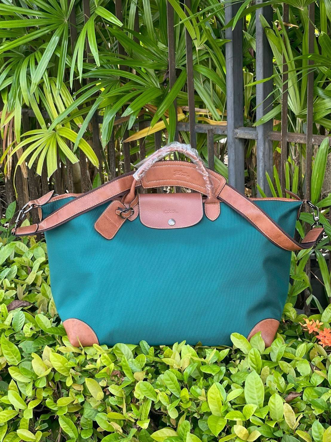 LONGCHAMP BOXFORD TRAVEL BAG L กระเป๋าเดินทางขนาดใหญ่ มาพร้อมสายสะพายที่สามารถถอดได้ ให้คุณเลือกสะพายไหล่หรือถือได้ มีซิปรูดเปิดปิดกระเป๋าที่ให้คุณมั่นใจได้ว่าคุณจัดเก็บไอเท็มของคุณได้อย่างมิดชิด บ็อคฟอร์ด (BOXFORD) สะท้อนความเป็นเอกลักษณ์ของแบรนด์ที่เปี่