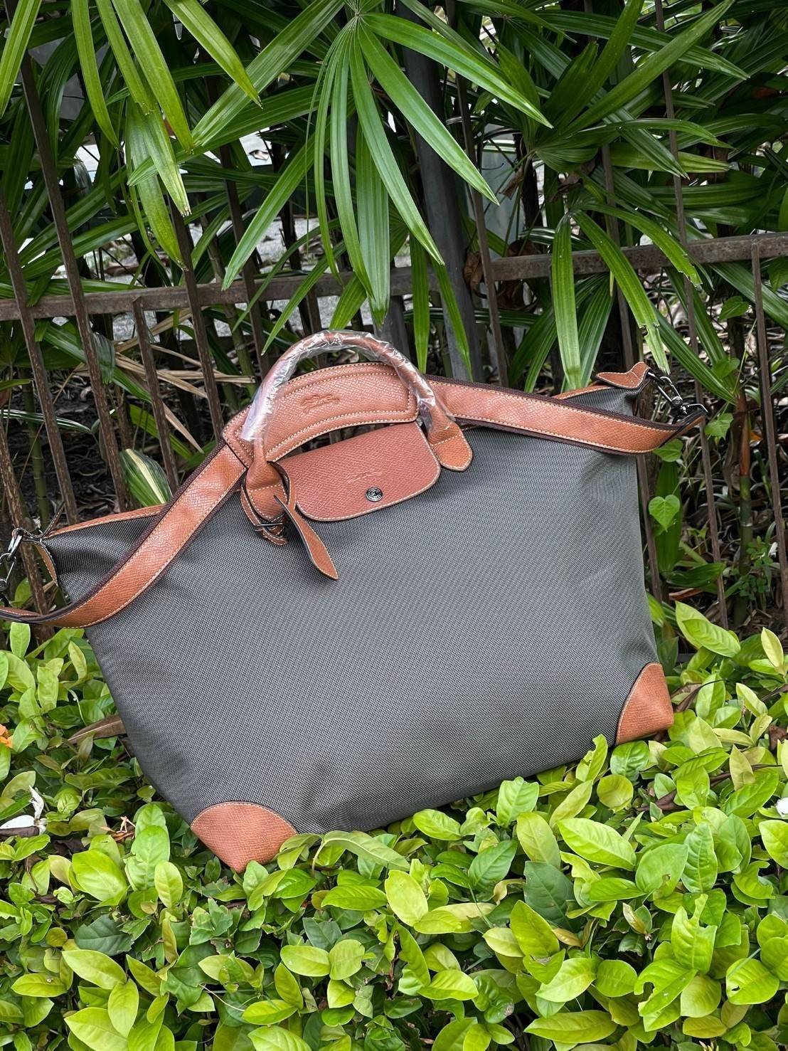 LONGCHAMP BOXFORD TRAVEL BAG L กระเป๋าเดินทางขนาดใหญ่ มาพร้อมสายสะพายที่สามารถถอดได้ ให้คุณเลือกสะพายไหล่หรือถือได้ มีซิปรูดเปิดปิดกระเป๋าที่ให้คุณมั่นใจได้ว่าคุณจัดเก็บไอเท็มของคุณได้อย่างมิดชิด บ็อคฟอร์ด (BOXFORD) สะท้อนความเป็นเอกลักษณ์ของแบรนด์ที่เปี่