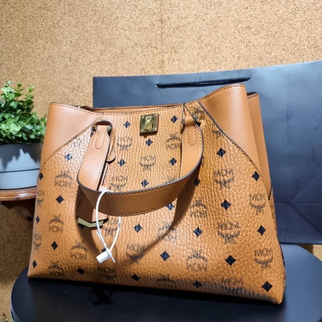 M.C.M ESSENTIAL TOTE IN VISETOS ความจุใจมาพร้อมเสิร์ฟแล้วจ้า ใครที่มองหากระเป๋าทรงโท้ทจุๆ ต้องใบนี้เลย!! กระเป๋าสะพายไหล่/ข้าง ดีไซน์ทรงสวยน่าใช้ วัสดุหนังแคนวาสสลับหนังแท้ ปากกระเป๋ามีตัวบิดล็อคแน่นหนากันของหล่นออกจากกระเป๋า ภายในโล่งกว้าง แบ่งสัดส่วนอย่