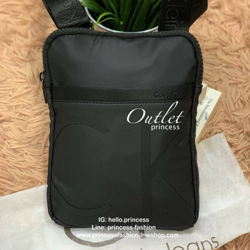 Cavin Klein Crossbody Bag กระเป๋าสะพายข้าง วัสดุหนังโพลีเอสเตอร์ น้ำหนักเบา สายสะพายปั้กโลโก้ ปรับความยาวได้ฟรีไซส์ ด้านหน้ามี1ช่องซิปใส่ของได้ หัวซิปปั้มโลโก้ทุกจุด เปิดปิดด้วยซิปเดียวด้านบน ด้านหน้ามีโลโก้เป็นอักษรย่อสวยงาม ขนาดกระเป๋าใส่มินิไอแพคกระเป๋