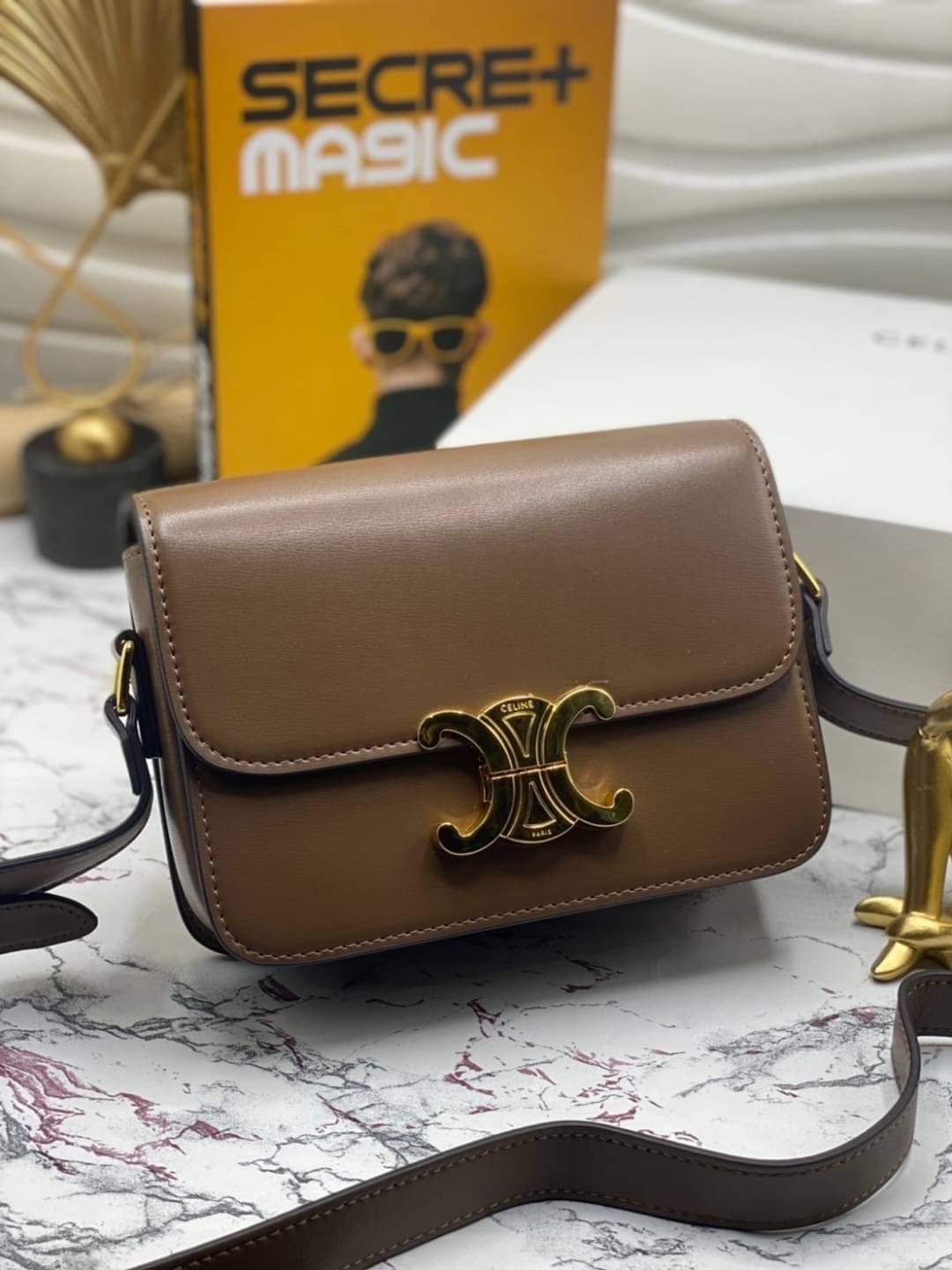 CELINE TRIOMPHE CROSSBODY BAG / CELINE TEEN ดีไซน์ยอดนิยมสไตล์ LISA ทรงสี่เหลี่ยมหนังสวยหรูอยู่ทรงเปิดปิดด้วยฝาปิดโลโก้แบรนด์อะไหล่ทอง ภายในมีช่องหลัก ช่องย่อย และช่องซิป สามารถใส่มือถือของใช้จุกจิกได้เยอะ มาพร้อมสายสะพายหนังยาวปรับระดับได้ จะสะพายไหล่ CR