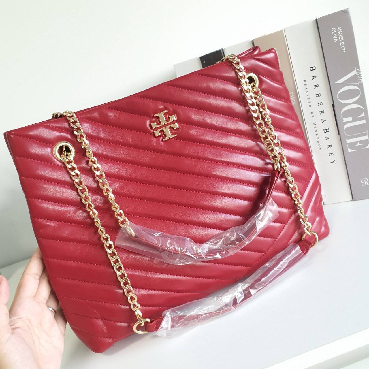 Tory Burch Kira chevron tote bag กระเป๋าทรง Tote สุดหรู ใบใหญ่ จุของได้เพียบ! วัสดุหนังแท้(Geniune Leather) หนังนิ่ม นุ่มมือมากกก มาพร้อมสายสะพายไหล่ต่อโซ่สลับหนัง อะไหล่ทองทั้งใบ ด้านข้างมีกระเป๋าเพิ่มทรงได้ ด้านในเปิดปิดด้วยกระดุมแม่เหล็ก มีช่องแบ่งใส่ข