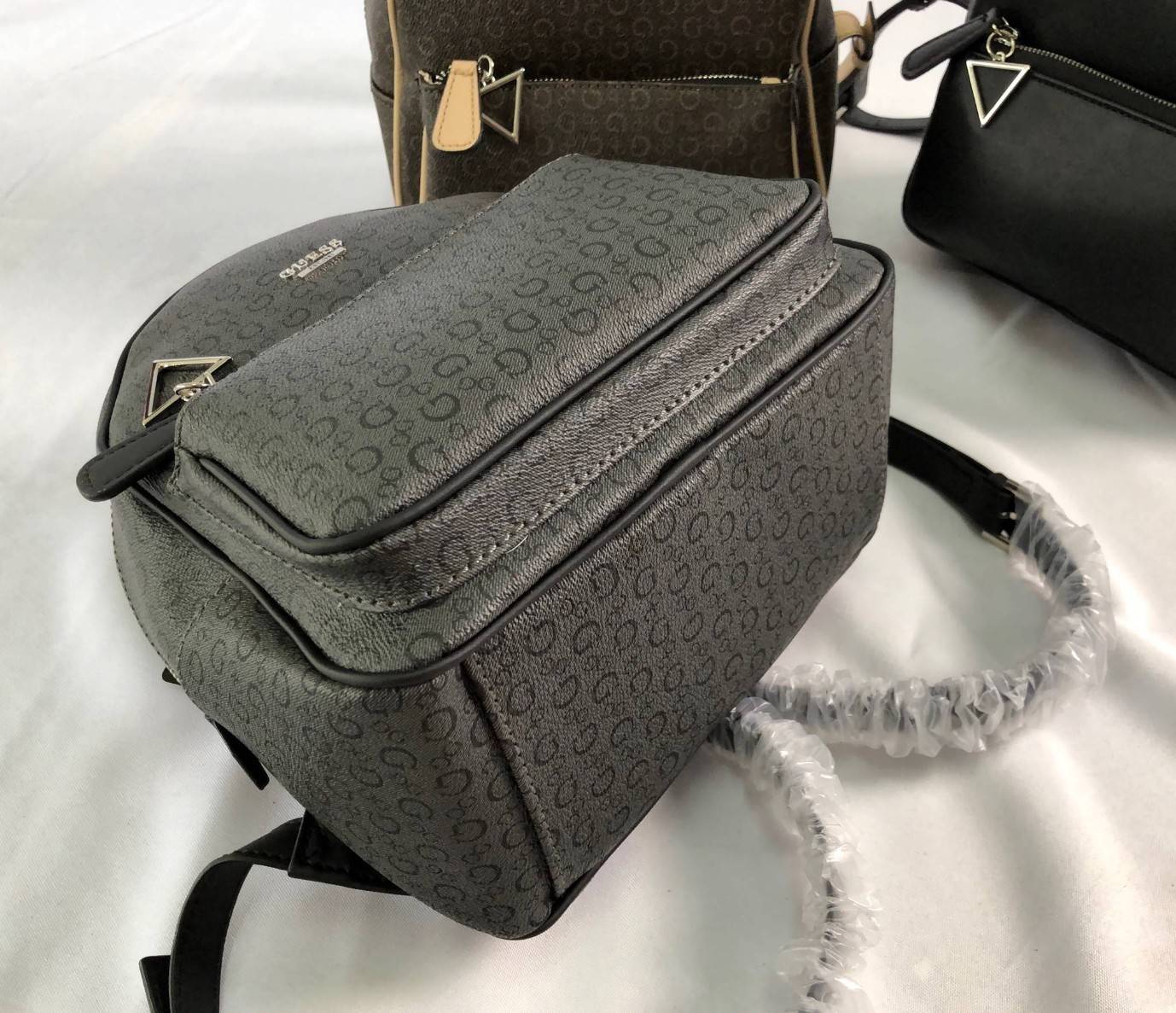 GUESS PANDORE BACKPACK กระเป๋าสะพายหลัง วัสดุหนังนิ่มมือ น้ำหนักเบา ด้านหน้ามีโลโก้แบรนด์ พร้อมช่องซิปหนึ่งช่อง ที่จับซิปมีอะไหล่สัญลักษณ์แบรนด์ ช่องซิปหลักเปิดปิดด้วยซิปคู่ ภายในโล่ง กว้าง ใส่ของได้จุ มีช่องซิปและช่องเล็กใส่ของจุกจิก สายสะพายด้านหลังเลื่