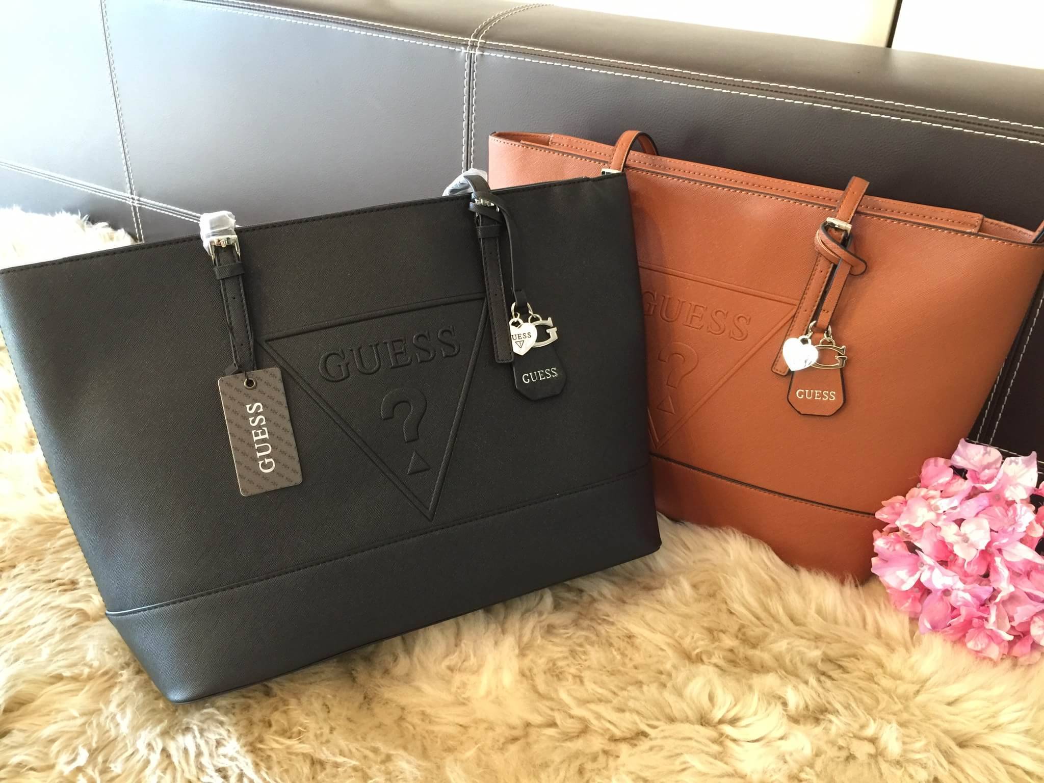 Guess Saffiano Shopping Bag กระเป๋าถือและคล้องบ่าทรงช้อปปิ้งใบใหญ่ หนังSaffiano ใส่เอกสารขนาด A4 ได้ จุของได้เยอะ ด้านหน้าสลักแบรนด์หนังลายนูนพร้อมประดับtagสายหนังถอดออกได้ เปิดปิดด้วยซิปเดียวด้านบน ภายในบุผ้าติดโลโก้ มีช่องเล็กและข่องใส่โทรศัพท์ เรียบง่า