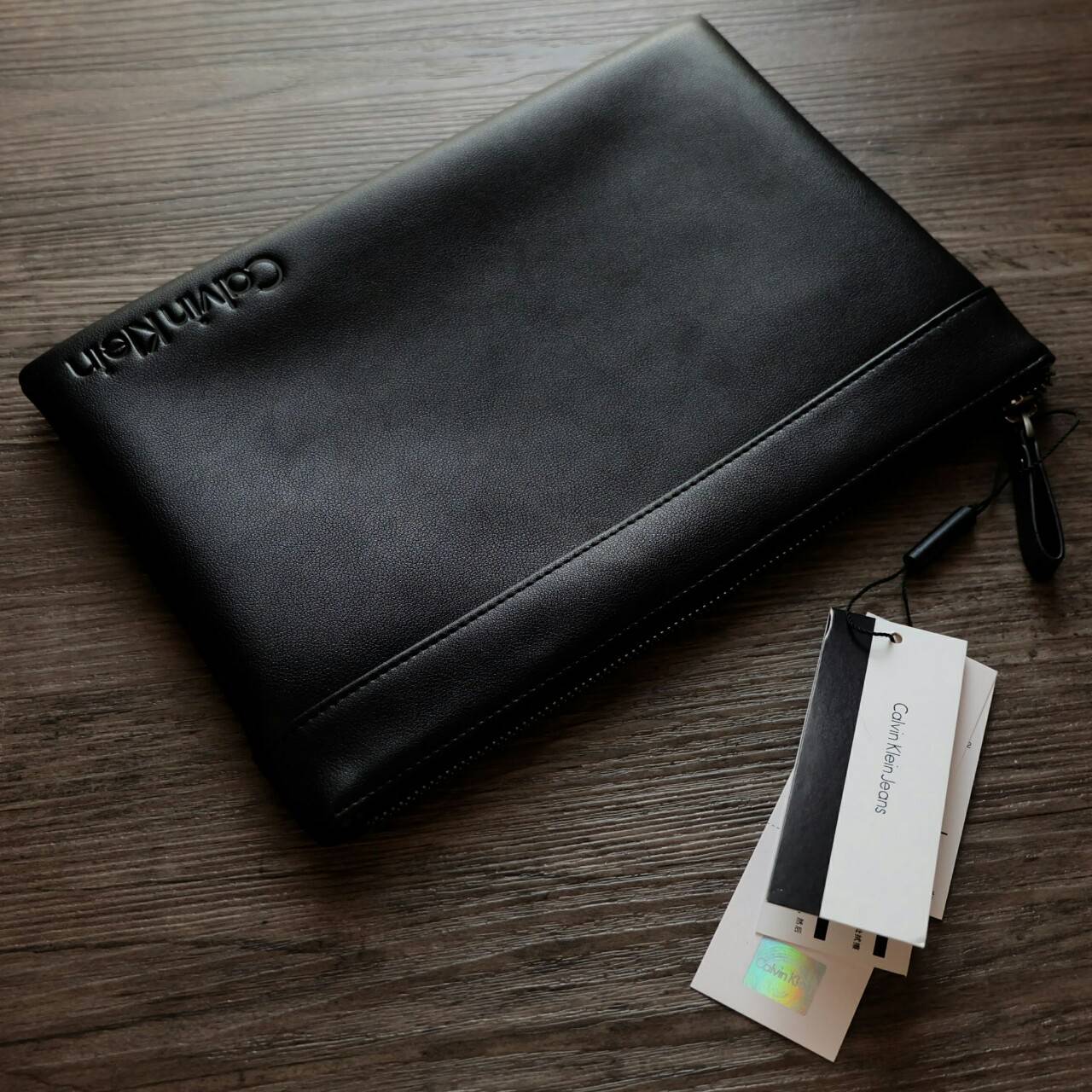 Cluth Bag Calvin Klein Cluth Bag กระเป๋าถือ ทรงคลัทช์ จากแบรนด์ Calvin Klein ด้านหน้า ปั๊มโลโก้แบรนด์ เปิด - ปิดกระเป๋าด้วยซิป ด้านในแบ่งเก็บของ ได้ 2 ช่องใหญ่ และมีช่องใส่บัตร 1 ช่อง สามารถใส่ iPad Mini ได้ค่ะ