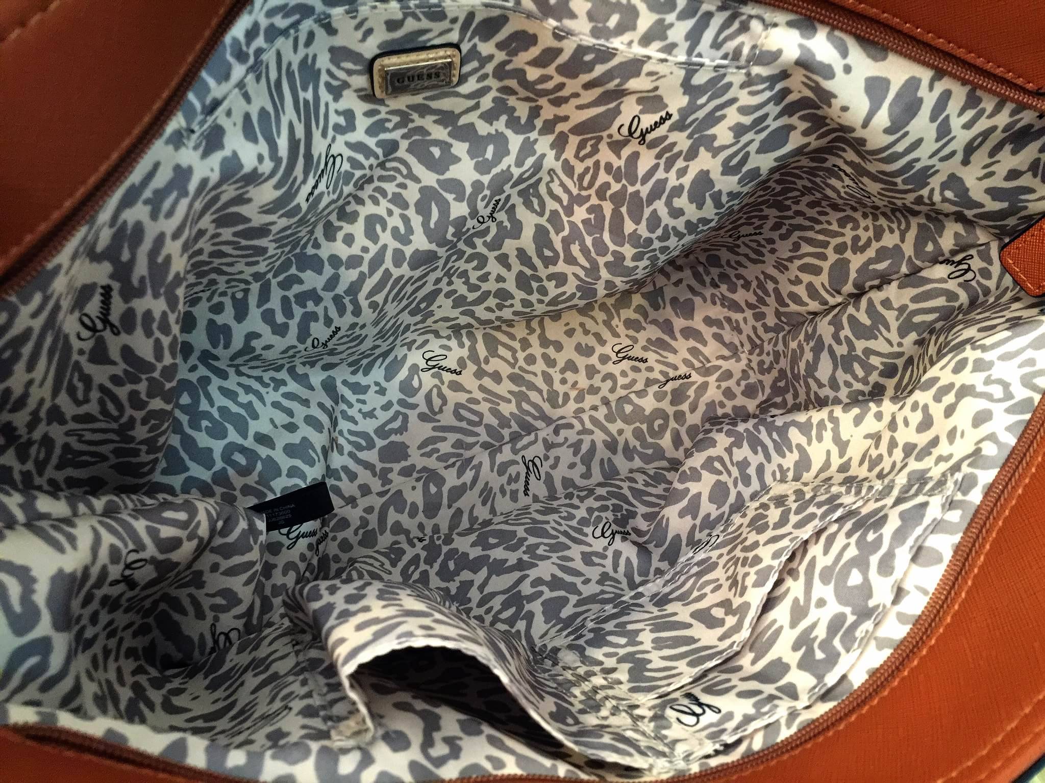 Guess Saffiano Shopping Bag กระเป๋าถือและคล้องบ่าทรงช้อปปิ้งใบใหญ่ หนังSaffiano ใส่เอกสารขนาด A4 ได้ จุของได้เยอะ ด้านหน้าสลักแบรนด์หนังลายนูนพร้อมประดับtagสายหนังถอดออกได้ เปิดปิดด้วยซิปเดียวด้านบน ภายในบุผ้าติดโลโก้ มีช่องเล็กและข่องใส่โทรศัพท์ เรียบง่า