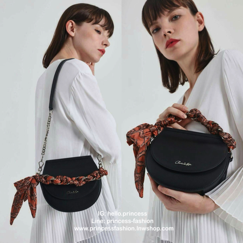CHARLES & KEITH รุ่น LEATHER SATIN SCARF CROSSBODY BAG SL2-50150828 ราคาปกติช้อป ( ฿3,590.00 ) กระเป๋าถือ และ สะพาย ทรงโค้งมน หนังเรียบ ตั้งอยู่ทรง ด้านหน้าติดโลโก้แบรนด์ อะไหล่เงิน หูจับสายกระเป๋าร้อยเข้ากับห่วงเหล็กกลมๆ ด้วยผ้าลายสวยงามผูกเป็นโบว์เก๋ๆ ถ