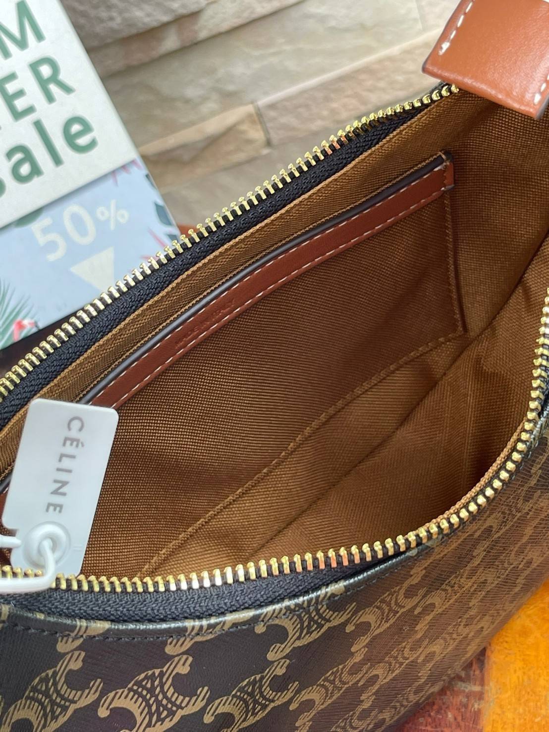 CELINE Vintage Classic Ava bag 1 ใน คอลเลคชั่น “Triomphe Canvas” มาพร้อมสายสะพายไหล่ที่ปรับความยาวได้ และเนื่องจากช่วงล่างของกระเป๋ามีขนาดใหญ่กว่าช่วงบน จึงทำให้ไม่เสียทรงเมื่อเราใส่สิ่งของอย่างกระเป๋าสตางค์หรือโทรศัพท์มือถือ หากดูภาพรวมแล้ว รุ่นนี้ออกแนว