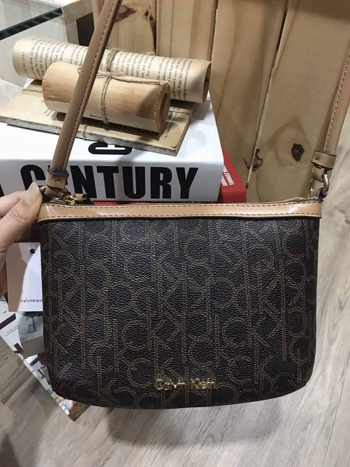 Calvin Klein Cross Body Bag กระเป๋าสะพายรุ่นใหม่ล่าสุดหนังสวย สกรีนลาย Signature แบรนด์รอบใบ ประดับโลโก้แบรนด์ สีทองด้านหน้า เปิดปิดด้วยซิป น้ำหนักเบา ภายใน โล่งกว้าง มีช่องใส่บัตร และช่องซิป ใส่ iphone+ ได้ มาพร้อมสายสะพายยาว ขนาดกำลังน่ารัก สะพายคล่องตั