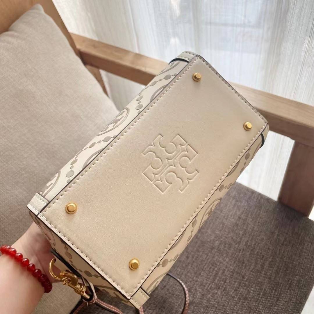 Tory Burch T-Monogram Mini Embossed Wine Bucket Bag / Tory Burch Mini Bucket กระเป๋าถือหรือสะพายไหล่ ทรงหมอนขนาดเล็ก ประดับด้วยลวดลายอันเป็นสัญลักษณ์ของแบรนด์ ถูกประดิษขึ้นด้วยความพิถีพิถันวัสดุหนังอย่างดี ด้านในบุด้วยหนังไมโครซูแอคเนื้อนุ่มทำความสะอาดง่า