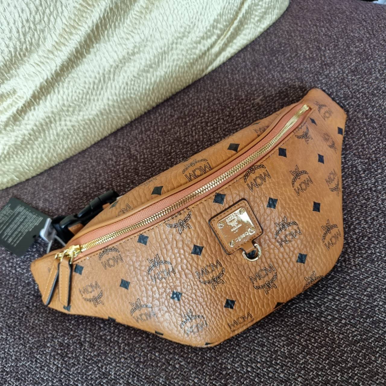 M.C.M FURSTEN BELT BAG IN VISETOS กระเป๋าคาดอกยอดฮิต หนุ่มๆสาวๆใช้ได้ไม่มีเบื่อ รุ่นขายดี ลายวิเซโต้เอกลักษณ์ ทั้งสปอร์ตและดูหรูในตัว ใช้งานง่าย ได้ทุกลุค วัสดุหนังแคนวาสคุณภาพดี มีช่องซิปหลัก และซิปด้านหลังกระเป๋า ภายในเป็นช่องโล่งบุผ้าซับอย่างดี รุ่น un