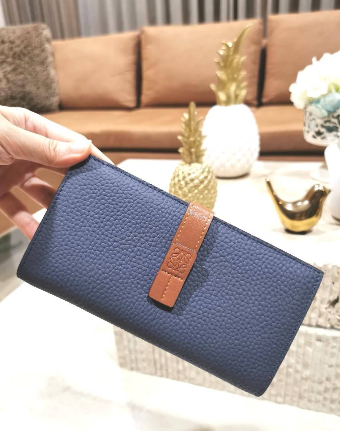 LOEWE LONG WALLET BAG วัสดุหนังแท้เทคเจอร์สวยอยู่ทรงปั้มโลโก้แบรนด์ด้านหน้าเปิดปิดด้วยกระดุม ภายในมีช่องใส่ธนบัตรหลายช่อง ช่องหลักสามารถใส่มือถือได้ มีช่องซิปใส่เหรียญ ช่องใส่ธนบัตรใส่แบงก์พันได้ สวยน่าใช้ พร้อมส่งที่ไทยสุดคุ้มห้ามพลาด!