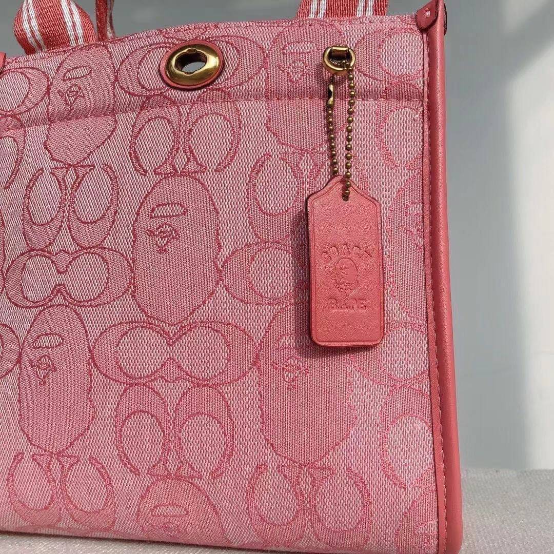 Coach Bape X Coach Tote 22 In Signature Jacquard กระเป๋าถือและครอสบอดี้โท้ทมินิไซส์ รุ่นใหม่สุดฮอต!! ใบจริงคือน่ารักม้ากกกก!! สวยอยู่ทรง มี 2 สี น่ารักน่าใช้ วัสดุหนังแคนวาส มาพร้อมหูจับในตัวและสายสะพายข้าง ถอดออกหิ้วเก๋ๆก็ได้ หรือสะพายถ่ายรูปชิคๆก็ดูดี ล