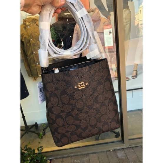 COACH SMALL TOWN BUCKET BAG IN SIGNATURE สำหรับสาวแฟชั่นที่ชอบรายละเอียดชิคๆ ดีไซน์สุดเก๋ แนะนำเลยสำหรับกระเป๋าทรงบักเก็ตใบนี้ เชื่อว่าสาว ๆ หลายคนชื่นชอบ เป็นไอเทมที่สามารถแมทช์ได้กับเสื้อหลากหลายสไตล์ บรรจุของได้เยอะโดยที่กระเป๋าไม่เสียทรง แบ่งช่องใช้งา