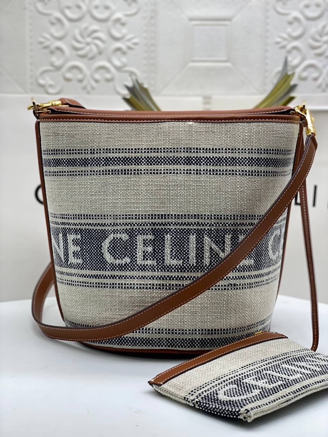 CELINE TEXTILE BUCKET BAG / CELINE TEEN BUCKET in STRIPED TEXTILE WITH JACQUARD ดีไซน์ทรง Bucket ใบใหญ่กำลังดี มาพร้อม Clutch ใบเล็กเข้าชุด เนื้อหนาแข็งแรง ภายในกว้างและจุใส่สัมภาระได้เยอะจุใจ อะไหล่แบรนด์สีทองสุดหรู