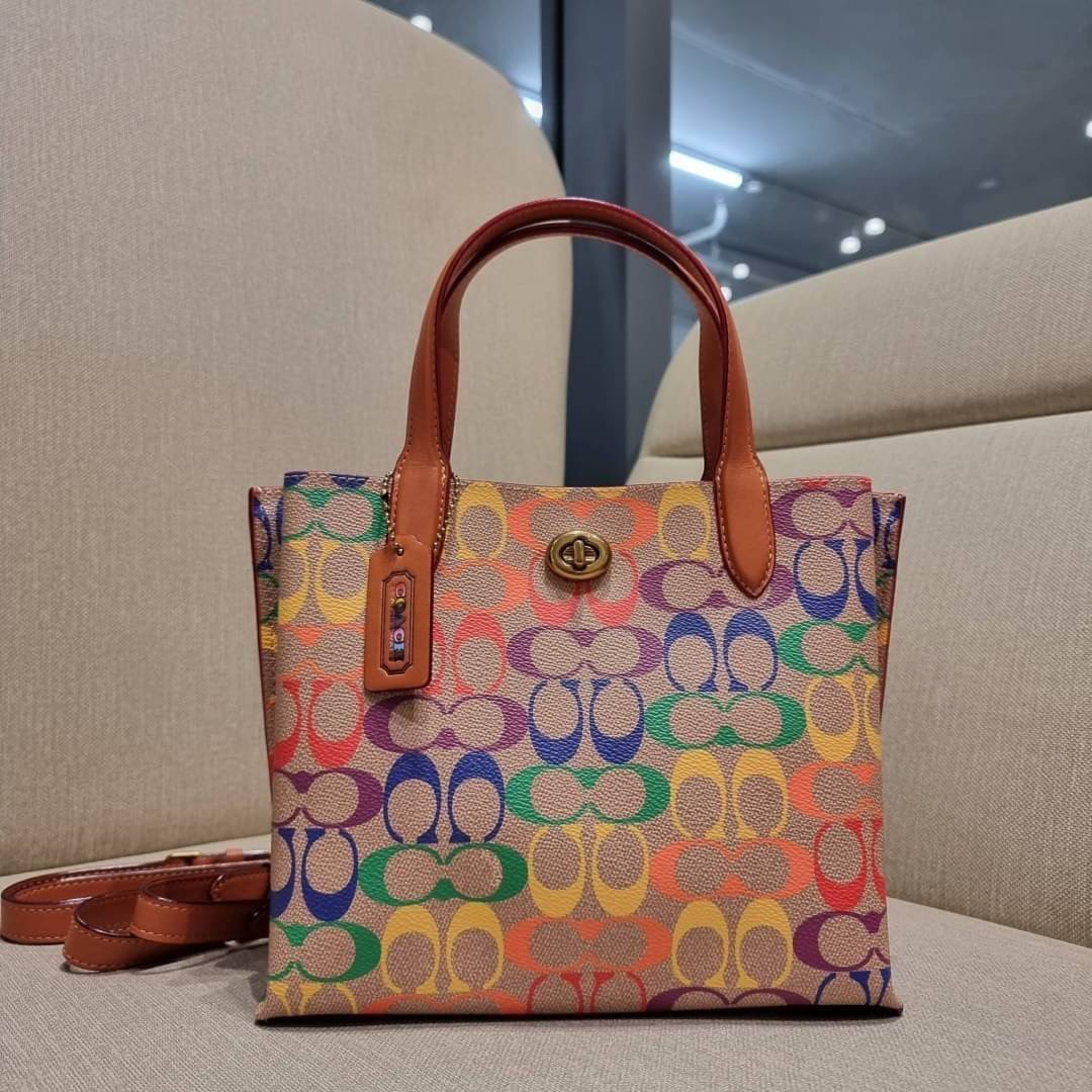 COACH CA102 WILLOW TOTE 24 IN RAINBOW SIGNATURE CANVAS ไปให้สุดกับความเลิศของลวดลายสายรุ้ง ที่แต่งแต้มลงบนกระเป๋าทรงโท้ท ไซส์กำลังสวย พกพาได้สะดวก มีตัวบิดล็อคที่ปากกระเป๋าด้านหนึ่ง และกระดุมแม่เหล็กอีกด้านหนึ่ง ภายในโล่งกว้าง เก็บของได้เป็นสัดส่วนไปเลย ม