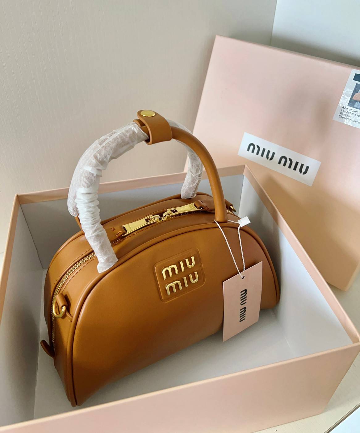 MIU MIU HALF-MOON TOP HANDLE BAG / Patent leather bowling bag / Miu Miu Leather top-handle bag กระเป๋าทรงพระจันทร์เสี้ยว หนังนิ่ม ลื่นเงา ตัดกับอะไหล่ทองได้ลงตัว