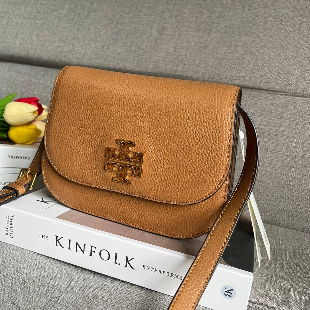 TORY BURCH BRLTTEN SMALL SADDLE BAG / Tory Burch Britten Flap Shoulder Bag กระเป๋าสะพายข้าง วัสดุหนังแกะแท้ ด้านหน้าประดับโลโก้แบรนด์ เปิด-ปิดกระเป๋าแบบกระดุมแป็กแม่เหล็กแน่นหนา ภายในมีช่องหลัก ใส่กระเป๋าเงินใบกลาง มือถือได้ทุกรุ่น มีช่องแยกใส่ของจุกจิกอี