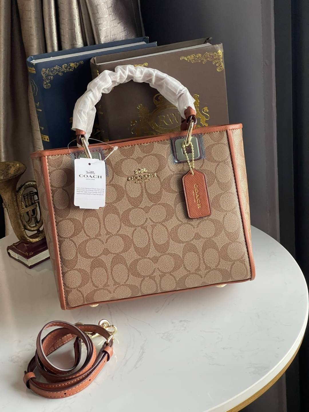 Coach Perry Tote Classic Bag F57568 รุ่นใหม่ล่าสุด กระเป๋ารูปทรงสี่เหลี่ยมสุดคลาสสิก เป็นกระเป๋าอเนกประสงค์ที่สามารถใช้ได้แทบทุกโอกาส ไม่ว่าจะไปเรียน, ไปทำงาน, ไปเที่ยว หรือแม้แต่ไปชอปปิง ด้วยขนาดที่กำลังดี ไม่ใหญ่เทอะทะ แต่ก็ไม่เล็กจนเกินไป มาพร้อมหูหิ้ว