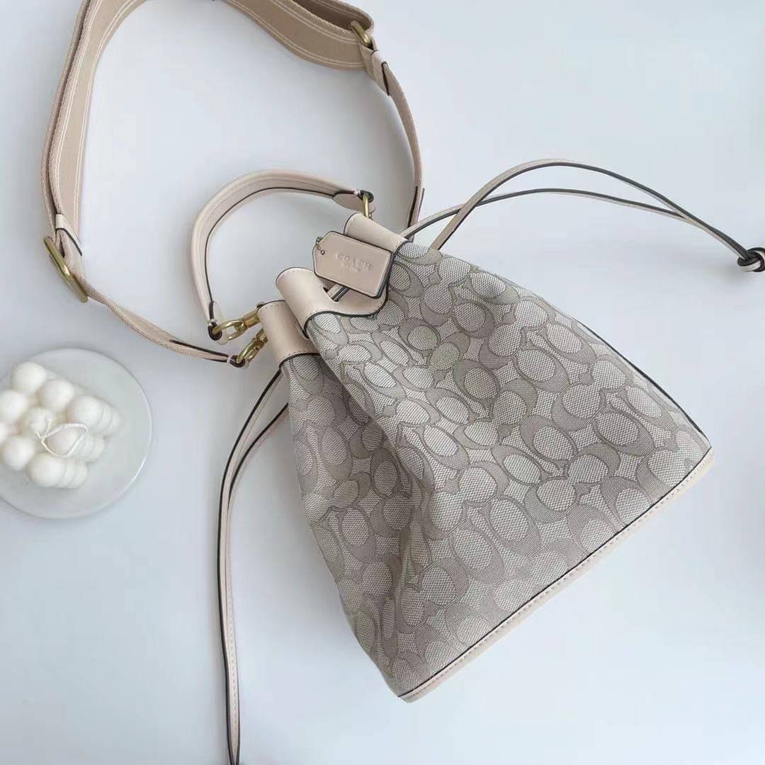 COACH FIELD BUCKET BAG IN SIGNATURE JACQUARD C3853 กระเป๋าสะพายทรงบัคเก็ต รุ่นใหม่ล่าสุด ดีไซน์ลายซิกเนเจอร์บนผ้า jacquard สวยคม เป็นเอกลักษณ์ไม่ซ้ำใคร มาพร้อมสายสะพายผ้าสปอร์ต และสายสั้นสำหรับคล้องแขนได้ สามารถรูดปิดปากกระเป๋าด้วยหนังรอบใบ เพิ่มดีเทลให้ต