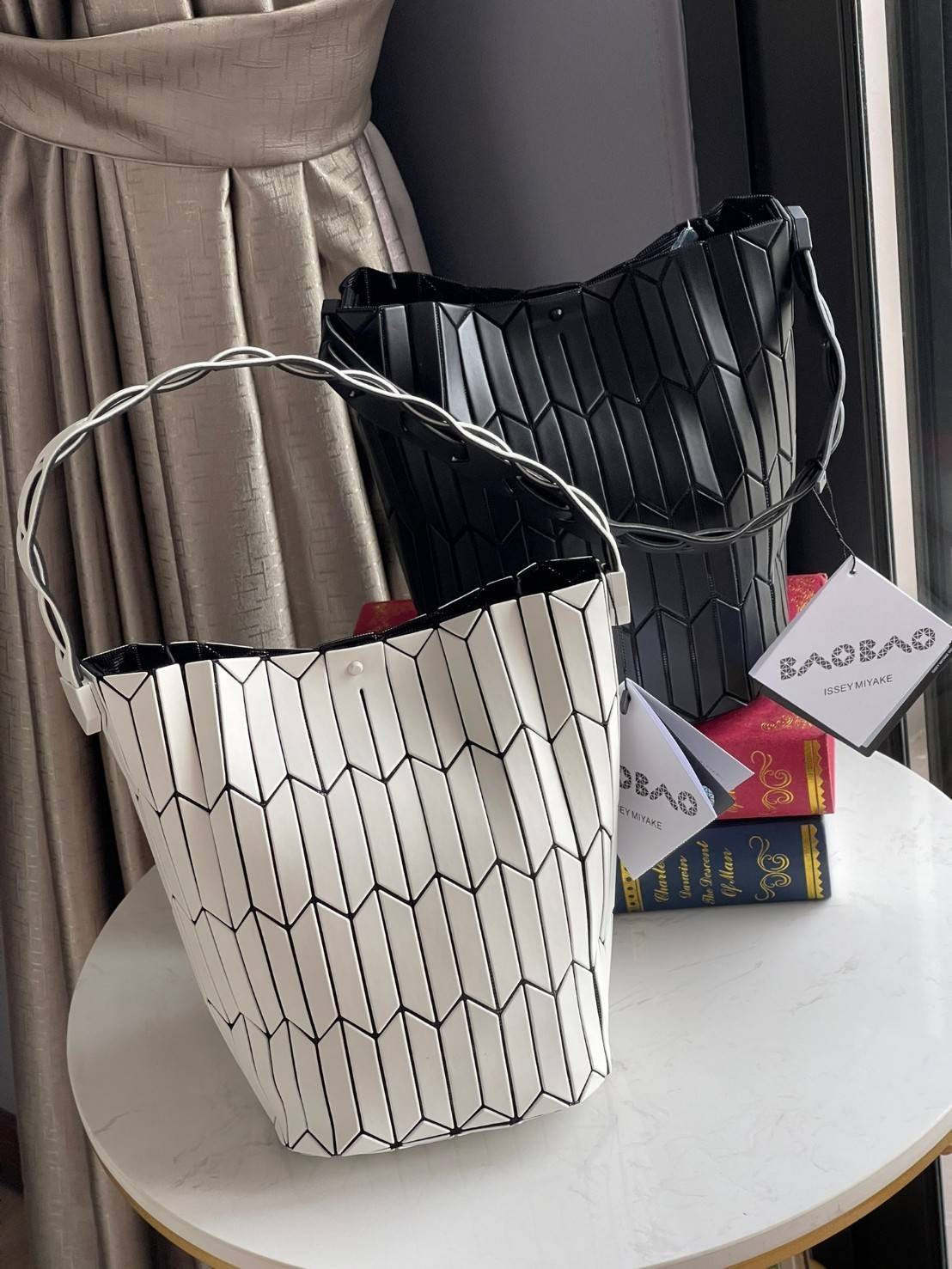 Large : Baobao Issey Miyake Large Bucket กระเป๋าบัคเก็ตขนาดใหญ่สามารถใช้ใส่ร่มพับได้หรือขวดน้ำขนาดเล็กได้ ซีรีย์ใหม่นี้มีจุดเด่นที่แผ่นรูปทรงสี่เหลี่ยมด้านขนานในแนวตั้ง เกิดเป็นรูปทรงสามมิติซึ่งแตกต่างไปจากรูปทรงที่เกิดขึ้นจากแผ่นสามเหลี่ยม หูหิ้วสามารถขย