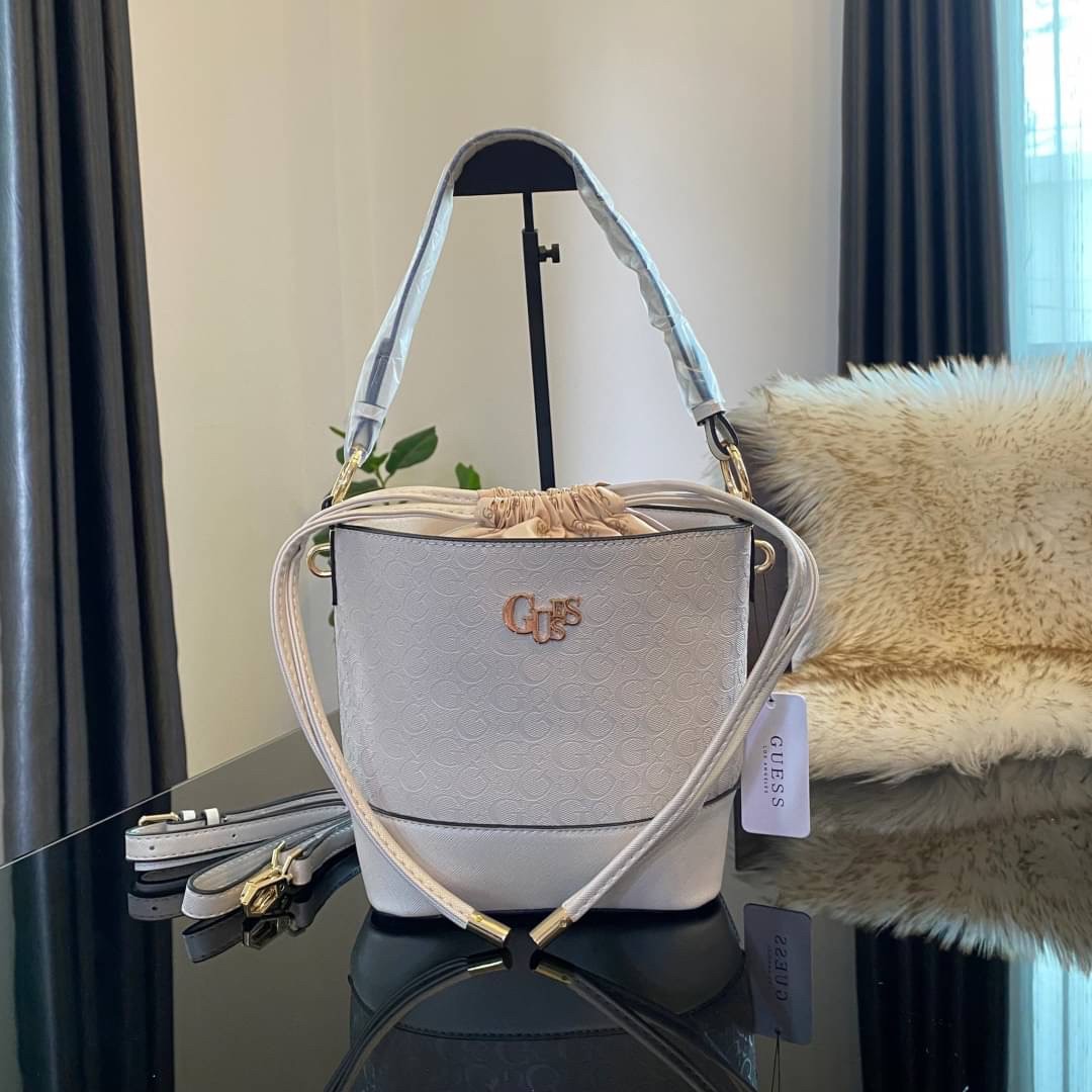 Guess Agata Bucket Handbag กระเป๋ารุ่นใหม่ล่าสุดทรงถังสุดน่ารัก พิมพ์ลายรอบใบ วัสดุ Saffiano PU คุณภาพดี นิ่ม น้ำหนักเบา ด้านหน้าประดับด้วยโลโก้แบรนด์สวยโดดเด่น เปิด-ปิดด้วยเชือกหนังใช้หูรูดปลายเชือกประดับอะไหล่ทองสะดวกใช้ ด้านในโล่งกว้างมีช่องเล็กสำหรับใ