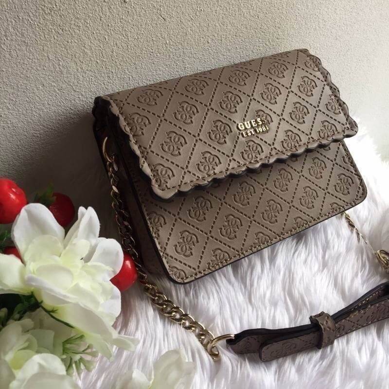 Guess Rayna Logo-Embossed Mini Crossbody กระเป๋าสะพายข้างทรง ครอสบอดี้ วัสดุหนัง pu ปั้มลาย Signature รอบใบรวมถึงสายยาว สวยตั้งอยู่ทรง ด้านหน้ามีโลโก้แบรนด์ เปิดปิดด้วยฝาปิดกระดุมแม่เหล็กซับในลายแบรนด์ มีช่องใส่บัตร ใส่มือถือ ของใช้จุกจิกได้เยอะ น้ำหนักเบ