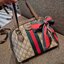 GC CLASSIC SATCHEL BAG กระเป๋าถือ/สะพายทรงโดม รุ่นหายาก สวยคลาสสิค แถมฟรี!! โบว์ผ้าลายแบรนด์ สำหรับตกแต่งหูกระเป๋า ผูกเป็นโบว์ หรือพันถนอมหูกระเป๋าก็เพิ่มดีเทลความหรูได้ วัสดุหนังแคนวาส ดีไซน์แถบคาดโดดเด่น เปิด-ปิดกระเป๋าด้วยซิป หัวซิปตัว G อะไหล่สีทอง เล
