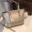 GUESS MINI CROSS BODY BAG กระเป๋าถือหรือสะพายรุ่นฮิตและขายดีที่สุดจาก GUESS FACTORY วัสดุหนังแก้วเงาสวยอยู่ทรง น้ำหนักเบา ด้านหน้าประดับด้วยโลโก้แบรนด์สุดหรูพร้อมปอมๆห้อยที่หูกระเป๋าถอดเเยกใช้ได้ เปิดปิดกระเป๋าด้วยซิปสะดวกใช้ ด้านในโล่งกว้างมีช่องซิปและช่